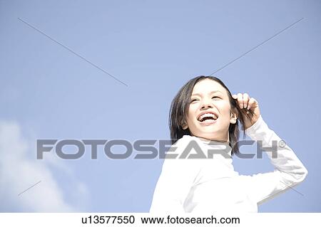 Woman below the blue sky View Large Photo Image Stock Image - Woman below the blue sky. Fotosearch