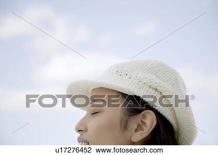 Stock Image - Woman below the blue sky. Fotosearch