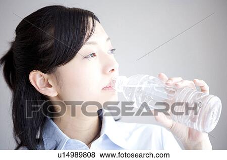 Woman drinking bottle of water View Large Photo Image Stock Photo - Woman drinking bottle of water. Fotosearch