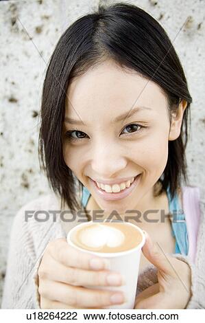 Woman drinking Cafe latte View Large Photo Image Stock Image - Woman drinking Cafe latte. Fotosearch