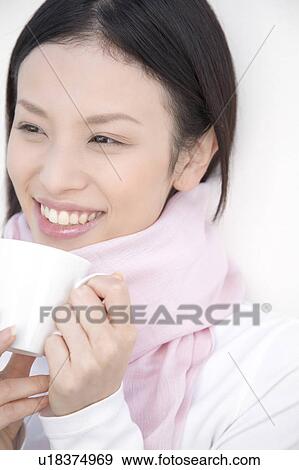 Stock Photo - Woman gripping a coffee cup. Fotosearch
