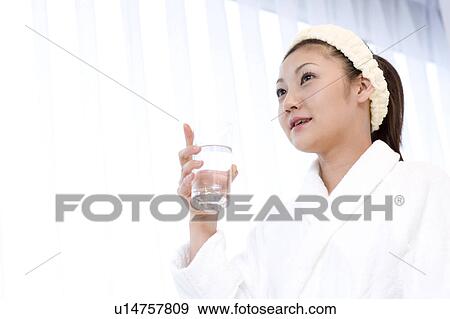 Woman holding a glass of water View Large Photo Image Stock Photo - Woman holding a glass of water. Fotosearch