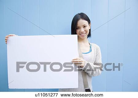 Woman holding a message board View Large Photo Image Stock Photo - Woman holding a message board. Fotosearch