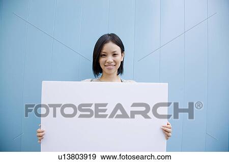 Woman holding a sign View Large Photo Image Stock Photo - Woman holding a sign. Fotosearch