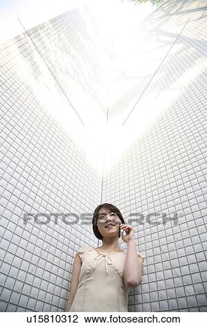 Woman holding cell phone View Large Photo Image Stock Image - Woman holding cell phone. Fotosearch