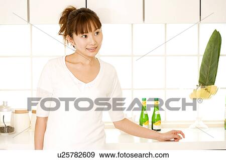 Stock Photo - Woman in kitchen. Fotosearch