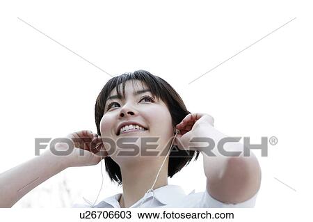 Stock Image - Woman listening to music. Fotosearch