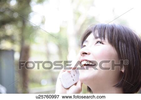 Stock Photo - Woman talking on cell phone. Fotosearch