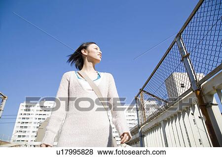 Stock Photo - Woman walking outdoors. Fotosearch