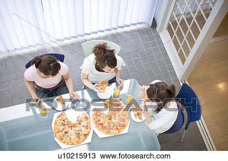 Women eating a pizza View Large Photo Image Stock Image - Women eating a pizza. Fotosearch