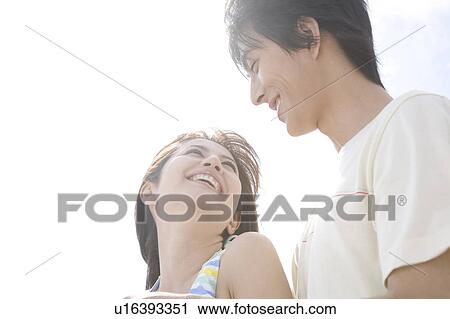 Stock Image - Young couple gazing at each other. Fotosearch