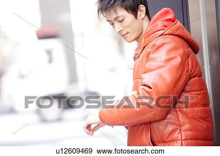 Stock Photo - Young man in winter coat. Fotosearch