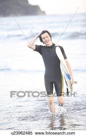 Young man surfing at Enoshima beach View Large Photo Image Stock Photography - Young man surfing at Enoshima beach. Fotosearch