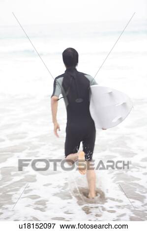 Stock Photo - Young man surfing. Fotosearch