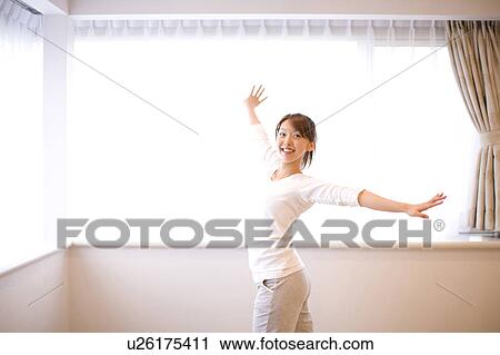 Stock Image - Young woman dancing. Fotosearch
