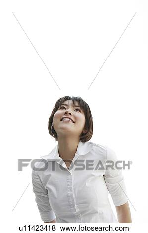 Stock Photo - Young woman looking up. Fotosearch