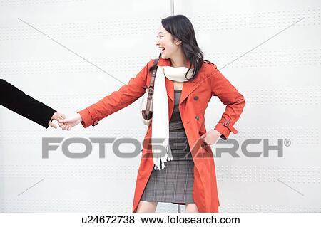 Young woman pulling boyfriend's hand View Large Photo Image Stock Photo - Young woman pulling boyfriend's hand. Fotosearch