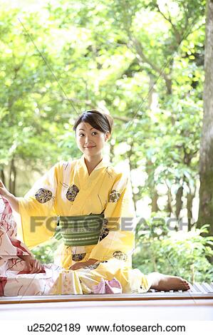 Young woman putting on a yukata View Large Photo Image Stock Photo - Young woman putting on a yukata. Fotosearch