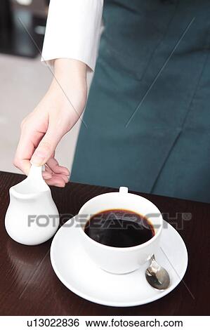 Stock Photograph - Young woman working as a waitress. Fotosearch