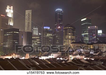 Buildings in a city lit up at night, Singapore View Large Photo Image Stock Image - Buildings in a city lit up at night, Singapore. Fotosearch