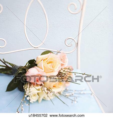 Close-up of a bouquet of flowers on a chair View Large Photo Image Stock Image - Close-up of a bouquet of flowers on a chair. Fotosearch