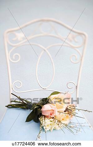 Stock Photograph - Close-up of a bouquet of flowers on a chair. Fotosearch