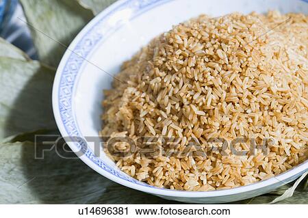 Stock Image - Close-up of a bowl of brown rice. Fotosearch