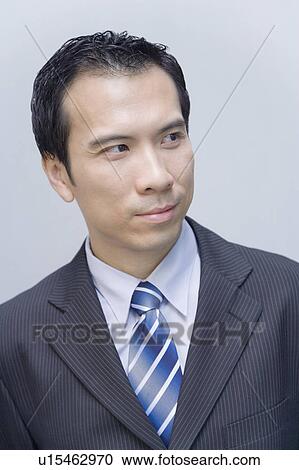Close-up of a businessman looking away View Large Photo Image Stock Image - Close-up of a businessman looking away. Fotosearch