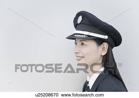 Stock Image - Close-up of a female pilot smiling. Fotosearch