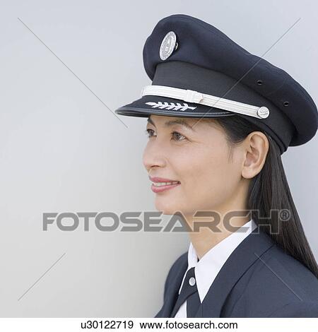 Close-up of a female pilot smiling View Large Photo Image Stock Photo - Close-up of a female pilot smiling. Fotosearch