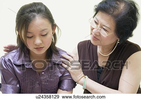 Stock Photo - Close-up of a senior woman consoling her daughter. Fotosearch