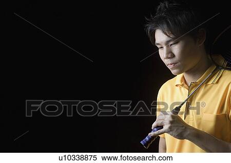 Close-up of a young man holding a badminton racket View Large Photo Image Stock Photography - Close-up of a young man holding a badminton racket. Fotosearch