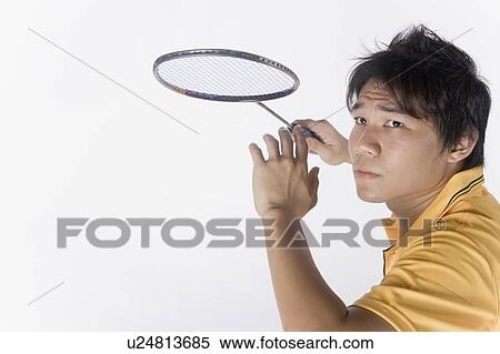 Stock Photography - Close-up of a young man playing badminton. Fotosearch