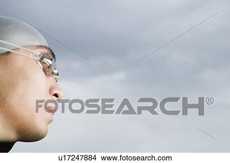 Picture - Close-up of a young man wearing swimming goggles. Fotosearch