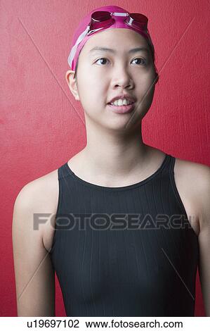 Stock Image - Close-up of a young woman wearing swimwear and smiling. Fotosearch
