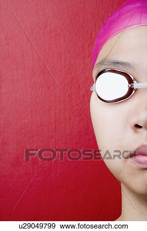 Close-up of a young woman wearing swimming goggles View Large Photo Image Stock Photo - Close-up of a young woman wearing swimming goggles. Fotosearch