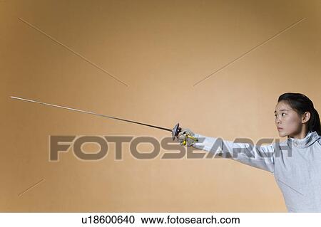 Female fencer fencing View Large Photo Image Stock Image - Female fencer fencing. Fotosearch