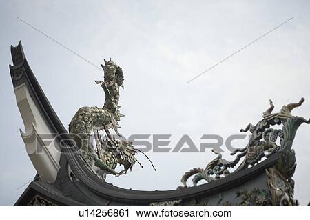 Stock Image - Low angle view of a dragon sculpture in a temple. Fotosearch