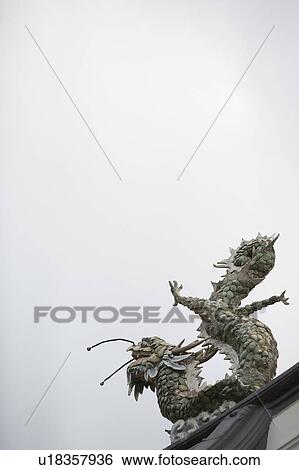 Stock Photograph - Low angle view of a dragon sculpture in a temple. Fotosearch