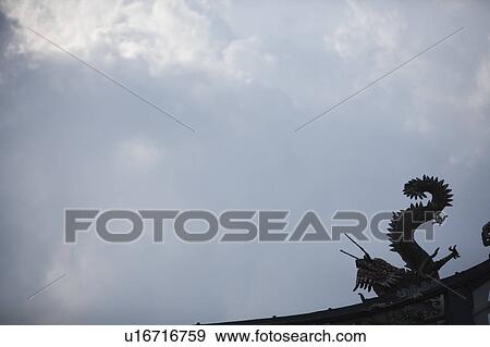 Stock Photo - Low angle view of a dragon sculpture on a temple. Fotosearch