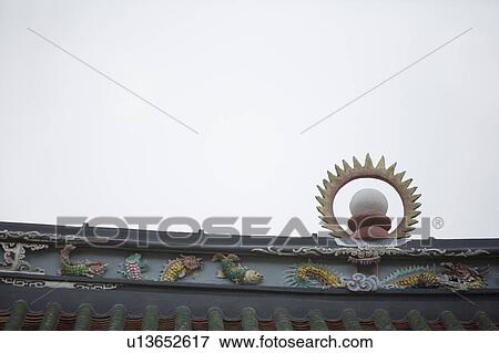 Low angle view of a sculpture on the roof of a temple View Large Photo Image Stock Photo - Low angle view of a sculpture on the roof of a temple. Fotosearch