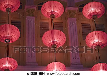 Low angle view of Chinese lanterns hanging in front of a building View Large Photo Image Picture - Low angle view of Chinese lanterns hanging in front of a building. Fotosearch