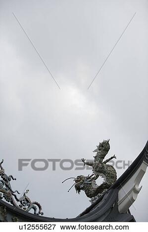 Stock Photo - Low angle view of dragon sculptures in a temple. Fotosearch