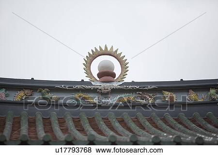 Stock Photo - Low angle view of sculptures on the roof of a temple. Fotosearch
