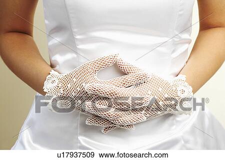 Mid section view of a bride wearing a pair of formal gloves View Large Photo Image Stock Photo - Mid section view of a bride wearing a pair of formal gloves. Fotosearch
