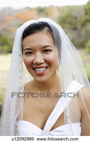 Stock Photo - Portrait of a bride smiling. Fotosearch