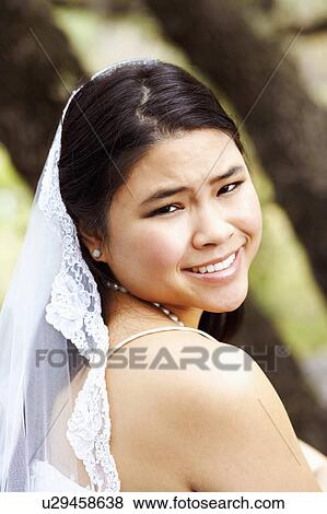 Stock Photo - Portrait of a bride smiling. Fotosearch