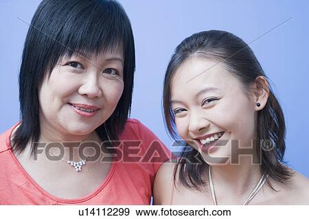 Stock Photo - Portrait of a mature woman and her daughter smiling. Fotosearch