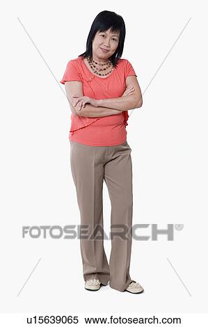 Portrait of a mature woman standing with her arms crossed View Large Photo Image Stock Photography - Portrait of a mature woman standing with her arms crossed. Fotosearch