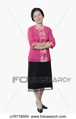 Portrait of a senior woman standing with her arms crossed View Large Photo Image Picture - Portrait of a senior woman standing with her arms crossed. Fotosearch